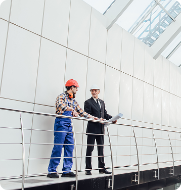 Engineers reviewing offshore fabrication blueprints on site